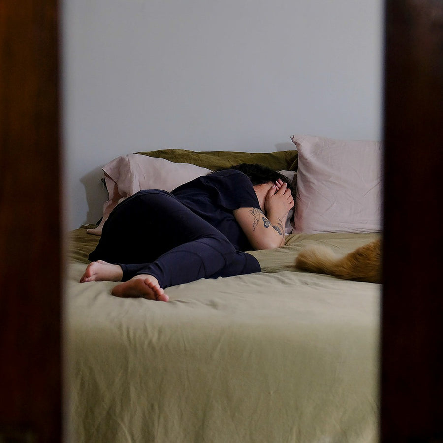 Someone curled up in bed at night